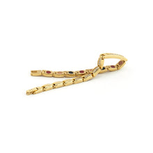 Adored gold stainless steel bracelet unclasped and folded to display crystal-accented links and polished finish.
