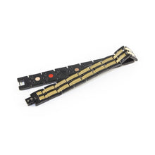 Aegis negative ion bracelet with black stainless steel and gold, unclasped and folded for display.