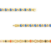 Close-up of Blue Belle bracelet showing round royal blue crystal set in each gold link.