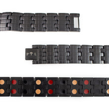 Close-up of Brilliant Black bracelet highlighting engraved checkered links and double embedded negative ion elements.