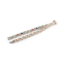 Continuum negative ion bracelet with stainless steel and rose gold, unclasped and folded for display.