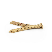 Dual Tone gold-plated titanium bracelet unclasped and folded to display link design with matte and polished gold contrast.