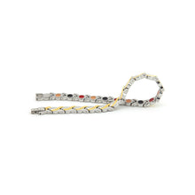Duet bracelet unclasped, displaying alternating gold and stainless steel wave links with single row of embedded elements.