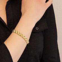 Close-up of female model with Golden Breath bracelet on wrist, emphasizing the elegant dual-finish gold link design.