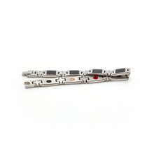 Impact stainless steel bracelet unclasped and folded to display carbon fiber window links and precise geometric spacers.