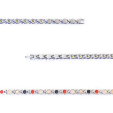 Close-up view of stainless steel links with green crystal accents and fine detailing.