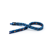 Majestic Blue bracelet unclasped and folded to display geometric pattern and reflective blue stainless steel finish.