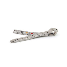 Maverick stainless steel bracelet unclasped and folded to display interlocking puzzle links, matte and polished contrast, and embedded negative ion elements.