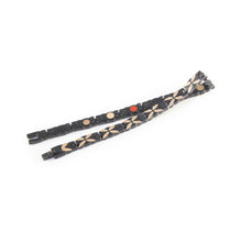 Monarch negative ion bracelet with matte black stainless steel and rose gold, unclasped and folded for display.
