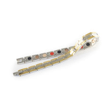 Nexus negative ion bracelet with stainless steel and gold, unclasped and folded for display.
