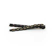 Perfect Balance bracelet unclasped and folded to display alternating black and gold links and refined craftsmanship.