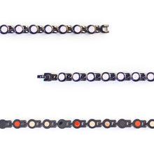 Close-up showing pink crystals and refined black interlocking links.