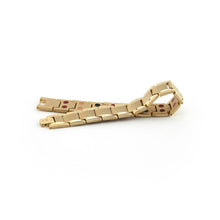 Royal matte gold stainless steel bracelet unclasped and folded to display angular links with polished border accents.