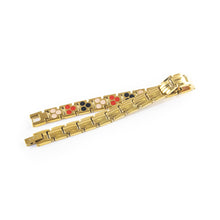 Solaris bracelet unclasped and folded to display gold-plated link design.