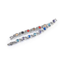 Symphony bracelet unclasped and folded to display polished steel links with crystals.