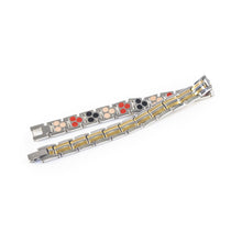 Twin Glow bracelet unclasped and folded to display striped link pattern.