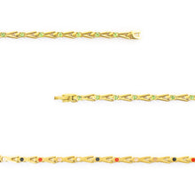 Close-up of Vitalis bracelet showing green crystals and interlocking gold-plated titanium links.
