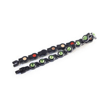 Bracelet laid flat and folded to display green crystals and link pattern.